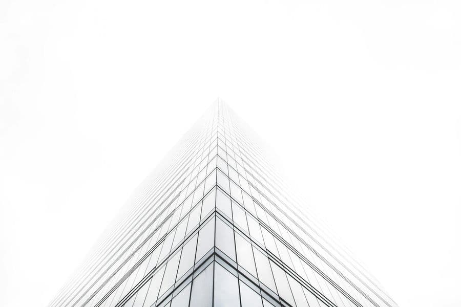 Bright glass office building fading into the sky
