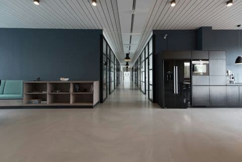 Minimal office corridor with dark glass doors