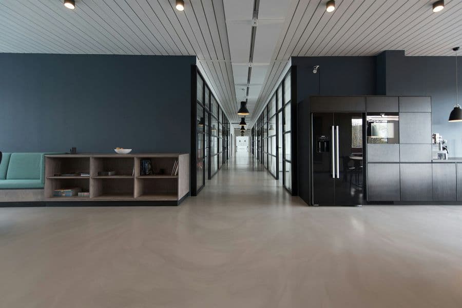 Minimal office corridor with dark glass doors